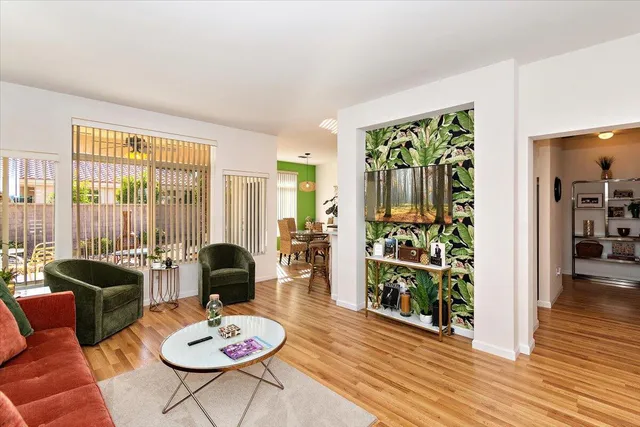 a living room with furniture and wooden floor