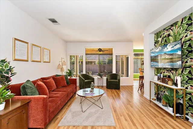 a living room with furniture a fireplace and a book shelf