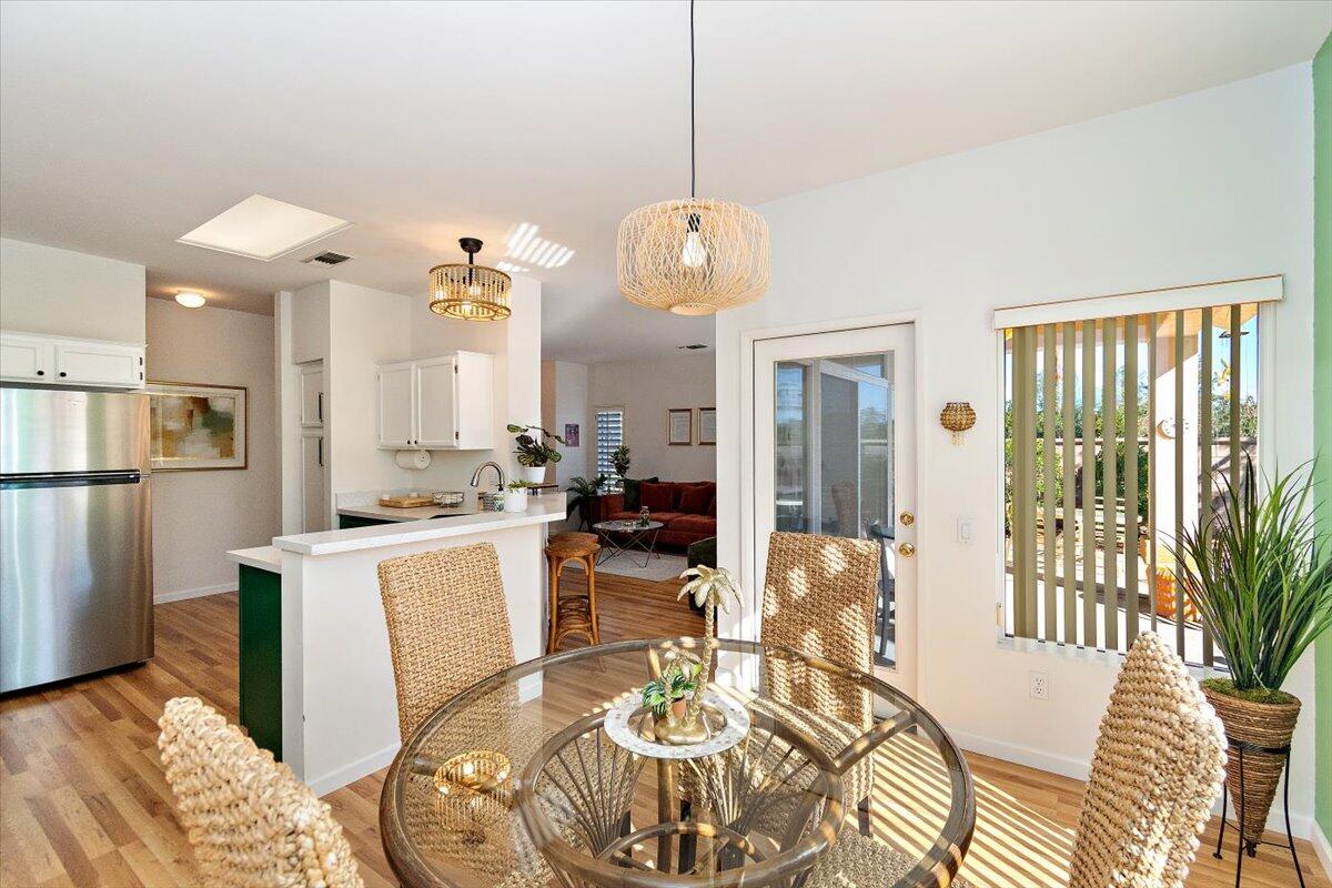 78995 Champagne Lane Palm Desert, CA 92211 - Photo 9 of 26 a view of a dining room with furniture window and wooden floor