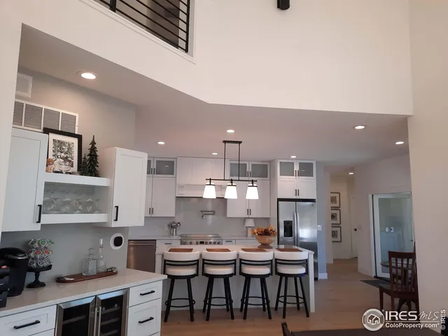 a kitchen with stainless steel appliances kitchen island granite countertop a sink and cabinets