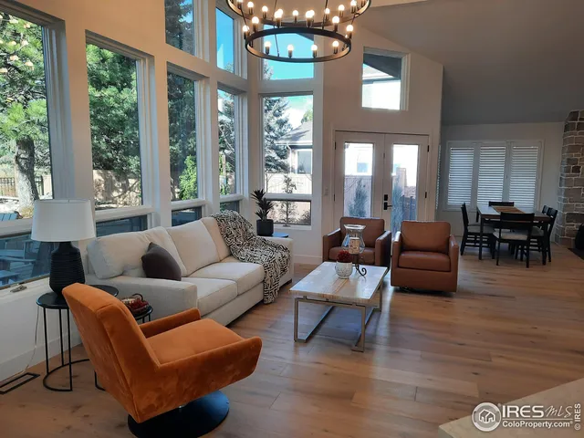 a kitchen with kitchen island granite countertop a stove oven and a view of living room