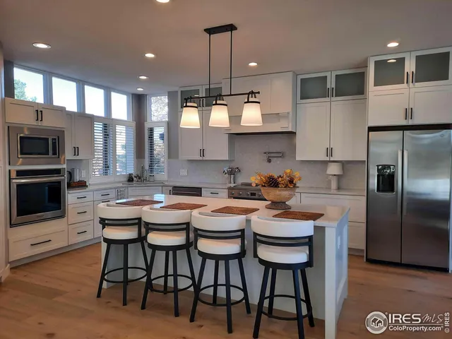 a kitchen with a dining table chairs and microwave