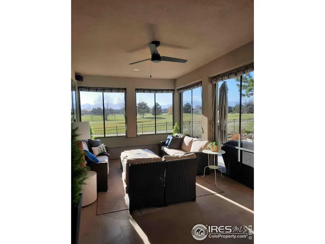a dining room with furniture and a large window