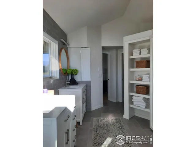 a living room with furniture and a hallway