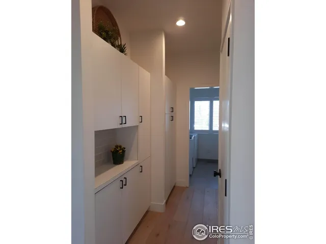 a bedroom with a bed and dresser with mirror