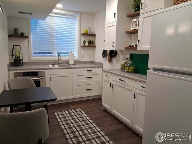 a kitchen with stainless steel appliances kitchen island granite countertop a sink and cabinets