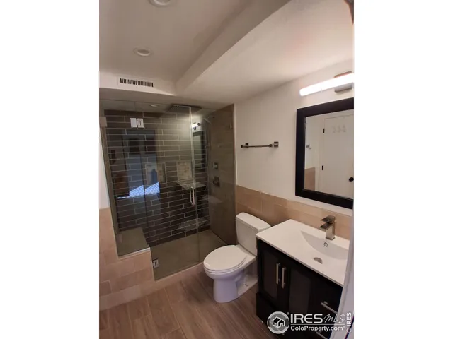 a bathroom with a toilet a sink and shower