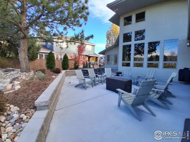 a building outdoor space with patio furniture and potted plants