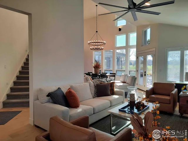 a living room with furniture and a chandelier