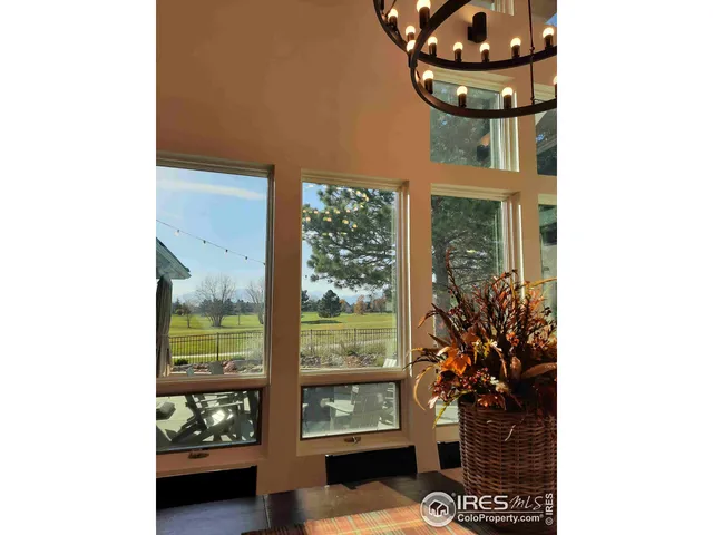 a vase of flowers sitting on a table with a potted plant