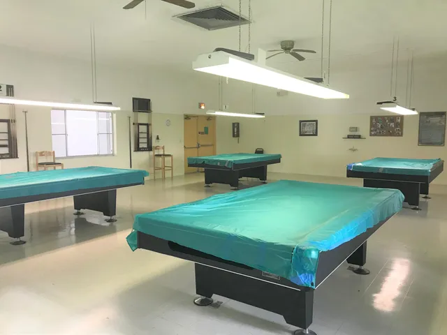 a room with pool table and windows