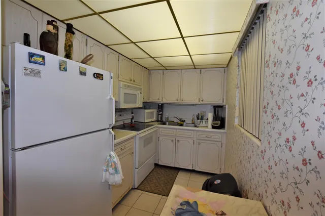 a kitchen with stainless steel appliances a refrigerator sink and cabinets