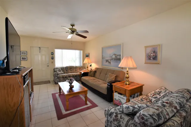 a living room with furniture a rug and a chandelier