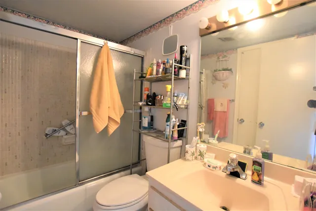 a bathroom with a sink toilet and shower