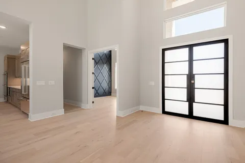 a living room with furniture a window and a flat screen tv