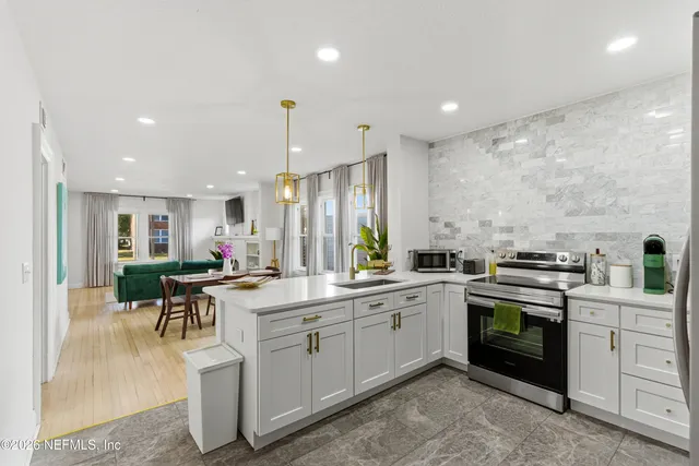 a kitchen with a sink stainless steel appliances and cabinets