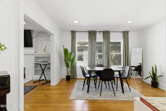 a view of a dining room with furniture window and wooden floor