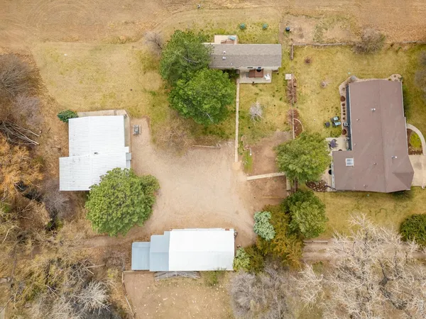 an aerial view of a house with a yard