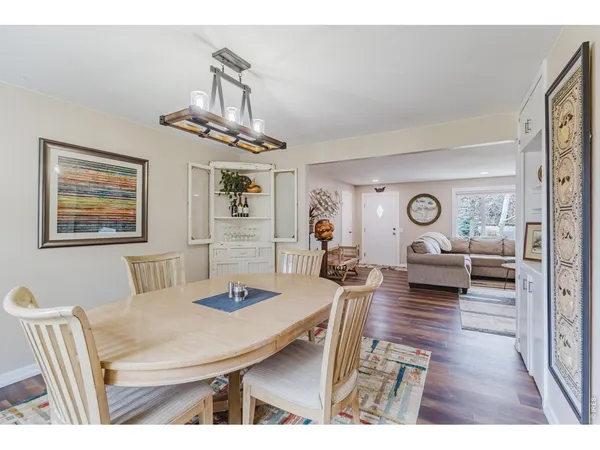 a living room with furniture a table and wooden floor