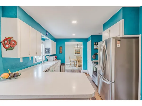 a kitchen with stainless steel appliances granite countertop a refrigerator and a sink