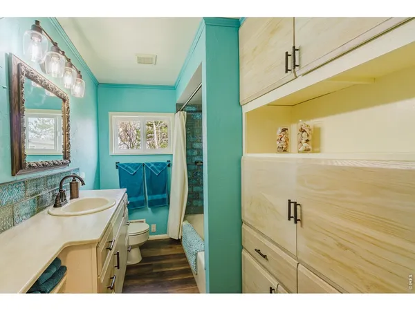 a bathroom with a sink a toilet and mirror