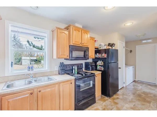 a kitchen with stainless steel appliances granite countertop a refrigerator stove top oven and sink