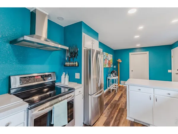 a kitchen with a refrigerator and a sink