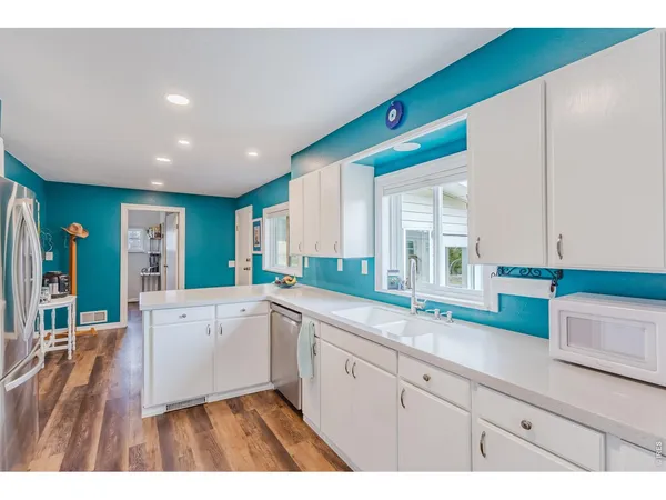 a kitchen with a sink cabinets and window
