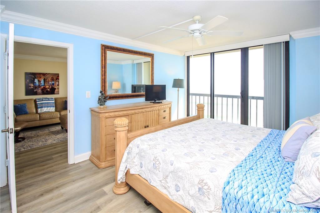 10680 South Ocean Drive, Unit 705 Jensen Beach, FL 34957 - Photo 17 of 45 a bedroom with a bed and wooden floor