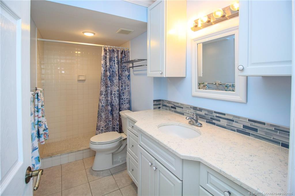 10680 South Ocean Drive, Unit 705 Jensen Beach, FL 34957 - Photo 19 of 45 a bathroom with a sink a toilet and shower