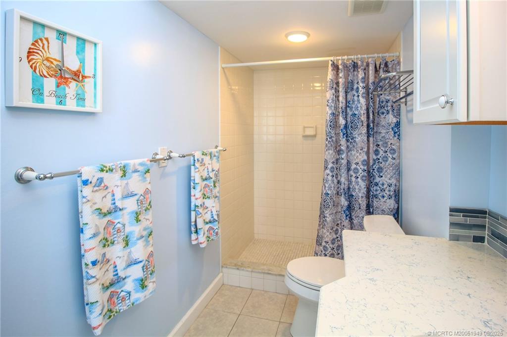 10680 South Ocean Drive, Unit 705 Jensen Beach, FL 34957 - Photo 20 of 45 a bathroom with a shower curtain and a curtain