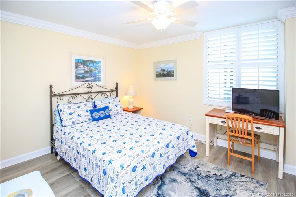 10680 South Ocean Drive, Unit 705 Jensen Beach, FL 34957 - Photo 22 of 45 a bedroom with a bed and a flat screen tv