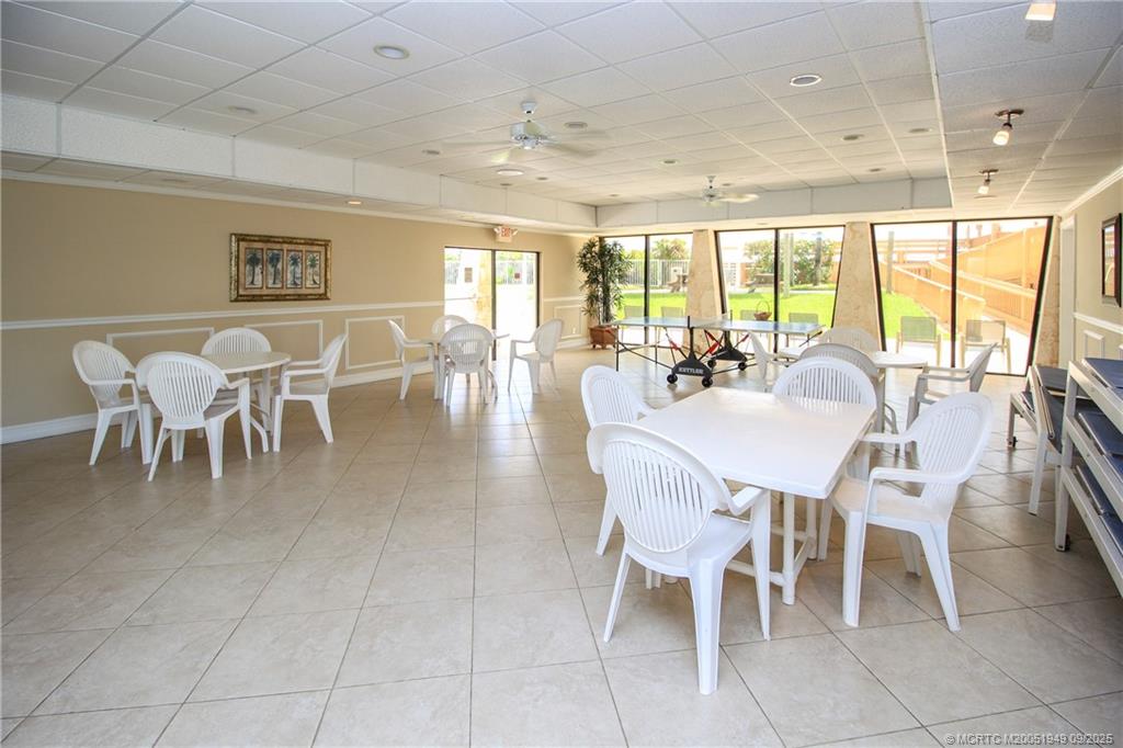 10680 South Ocean Drive, Unit 705 Jensen Beach, FL 34957 - Photo 33 of 45 a dining room with furniture a chandelier and a rug