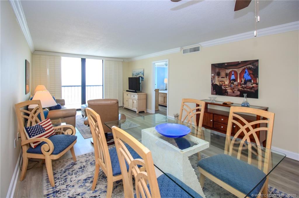 10680 South Ocean Drive, Unit 705 Jensen Beach, FL 34957 - Photo 8 of 45 a living room with furniture and a flat screen tv