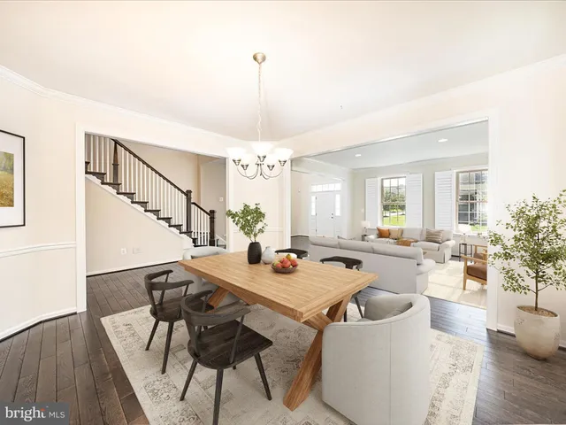 a kitchen with a sink stainless steel appliances and wooden floor