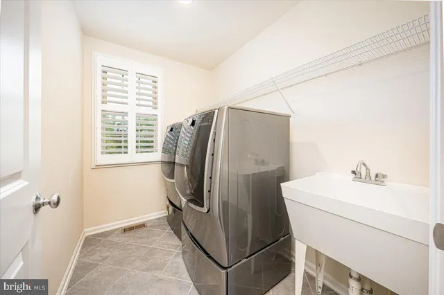 an aerial view of a house with a garden and swimming pool
