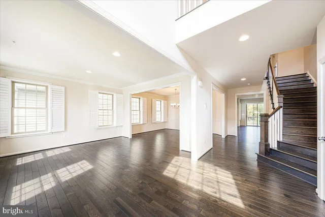 a living room with furniture and large windows