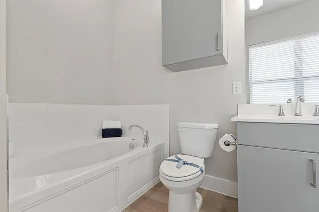 a white toilet sitting next to a bathroom sink