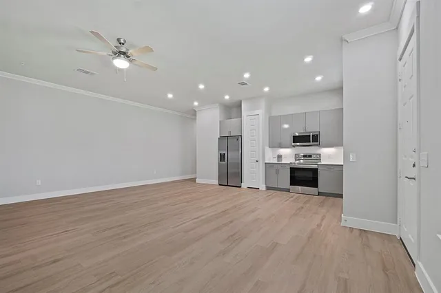 a view of kitchen with stove and refrigerator