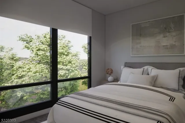 a bedroom with a large window and a bed