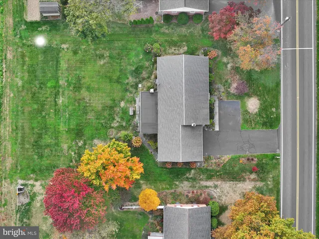 an aerial view of a house with a yard and garden