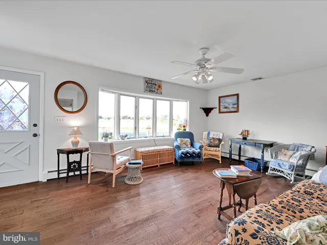 a living room with furniture a table and a large window