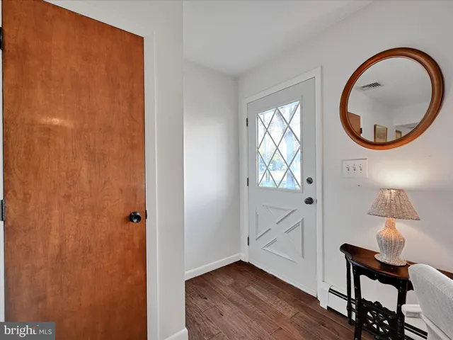 a view of an entryway with wooden floor