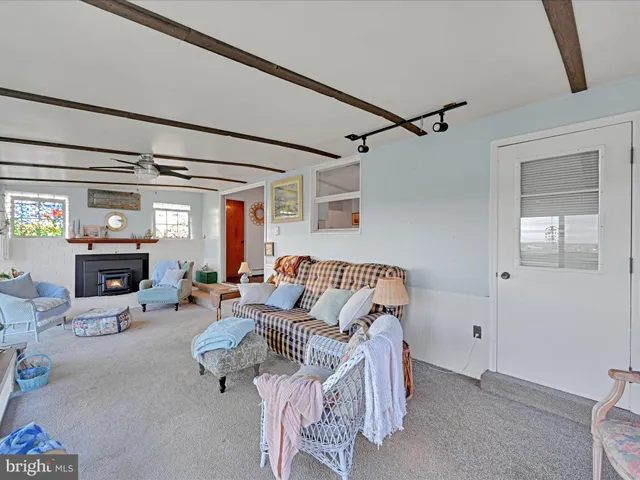 a living room with furniture a fireplace and a flat tv screen