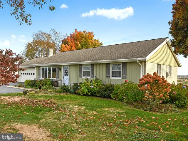 a front view of a house with garden and porch