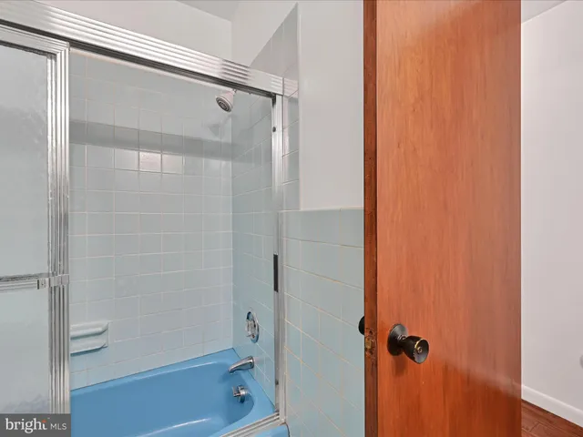 a bathroom with a glass shower door