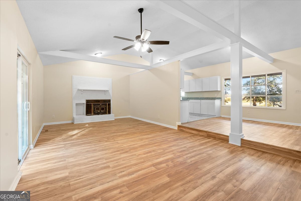 126 Waterfront Way Warner Robins, GA 31093 - Photo 15 of 60 a view of empty room with wooden floor fireplace and a window