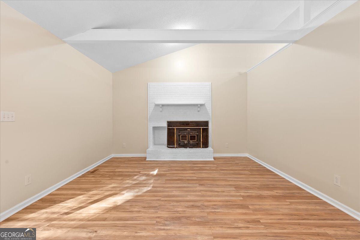 126 Waterfront Way Warner Robins, GA 31093 - Photo 20 of 60 a view of empty room with wooden floor and fireplace