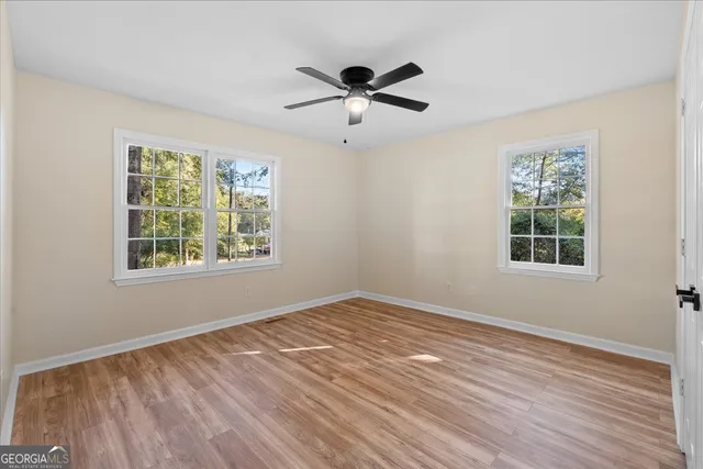 wooden floor in an empty room with a window