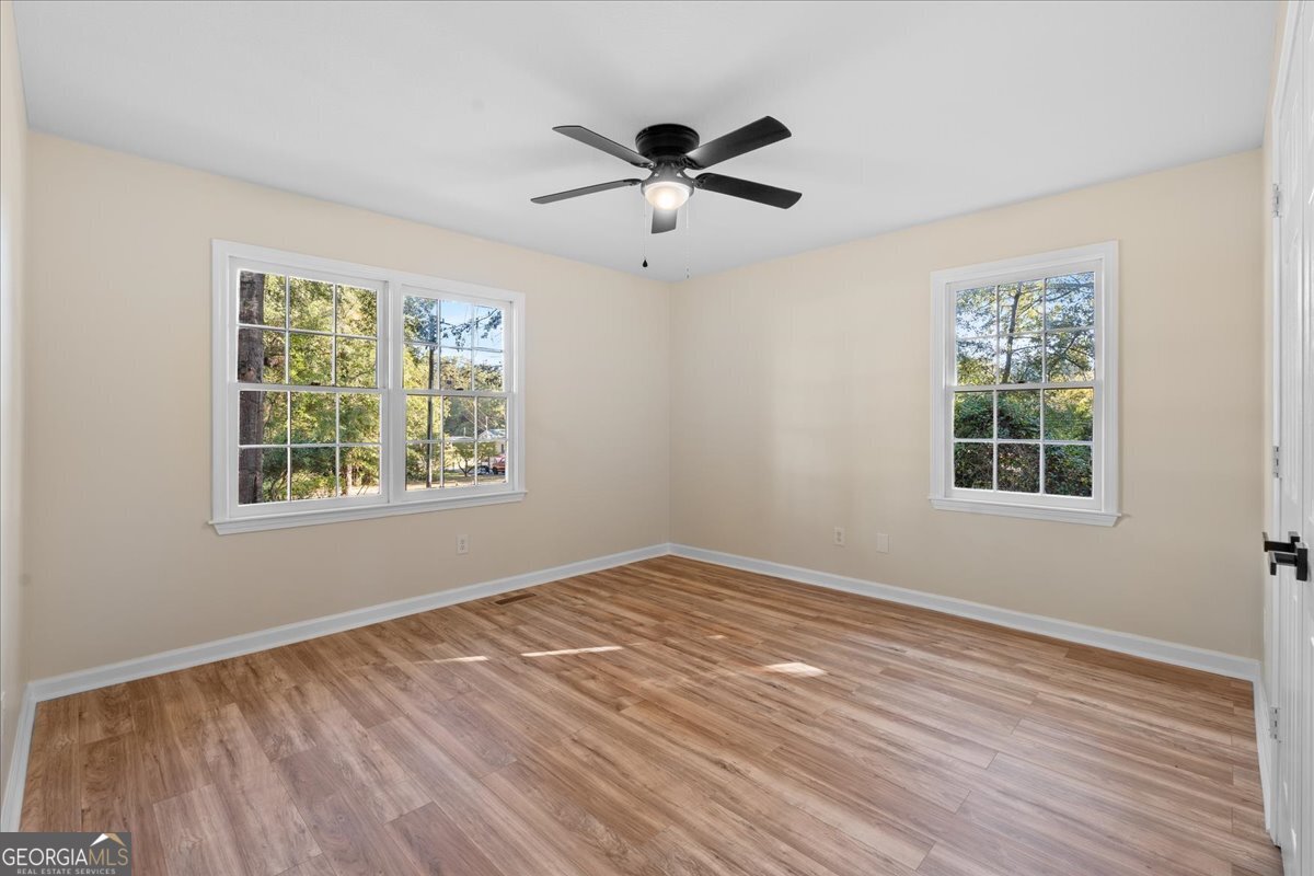 126 Waterfront Way Warner Robins, GA 31093 - Photo 21 of 60 a view of an empty room with wooden floor and a window